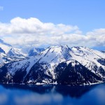 Photo of Blue skies, Cumulus clouds, reflection, bright blue water, mountains, snow, Garibaldi Lake, BC